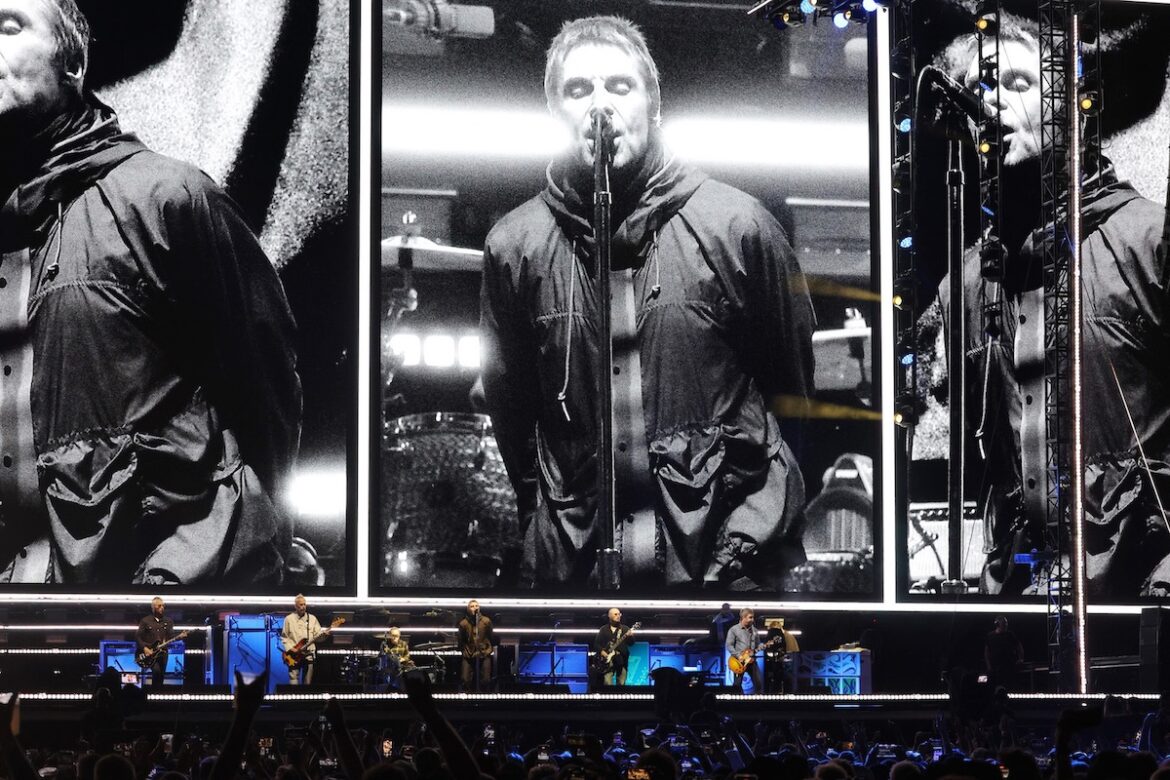 Liam and Noel Gallagher perform onstage at the Oasis Live '25 Toronto concert at Rogers Stadium on August 24 in Toronto, Ontario. (Credit: Kevin Mazur/Getty Images)