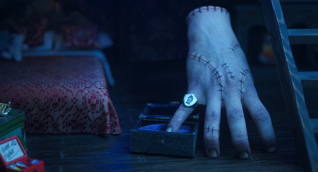 ‘Wednesday’ Creators Break Down Thing's Backstory In Season 2